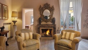 A cozy living room with a fireplace, two armchairs, a lamp, and a mirror. - Casa Mordigallina, in Sorrento Centre (Sorrento)