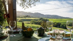 A table set for a meal with a scenic view of rolling hills and a clear sky. - Villa Biancospino - Private Villa with Pool (Chianni)