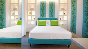 A modern bedroom with a large bed, teal accent pillows, and wall-mounted shelves with decorative items. - Resort Lubrense - Mandragola with pool and jacuzzi (Sant'Agata Sui Due Golfi)