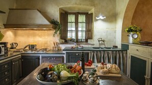 Una cocina con una isla central, estufa y pileta.