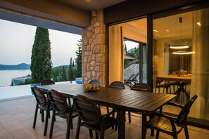Enjoy a casual meal in this outdoor dining area with a large table and comfortable seating for six.