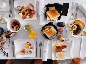 A breakfast setting with various food items and utensils on a table. - Grand Mercure Chengdu East (Chengdu)