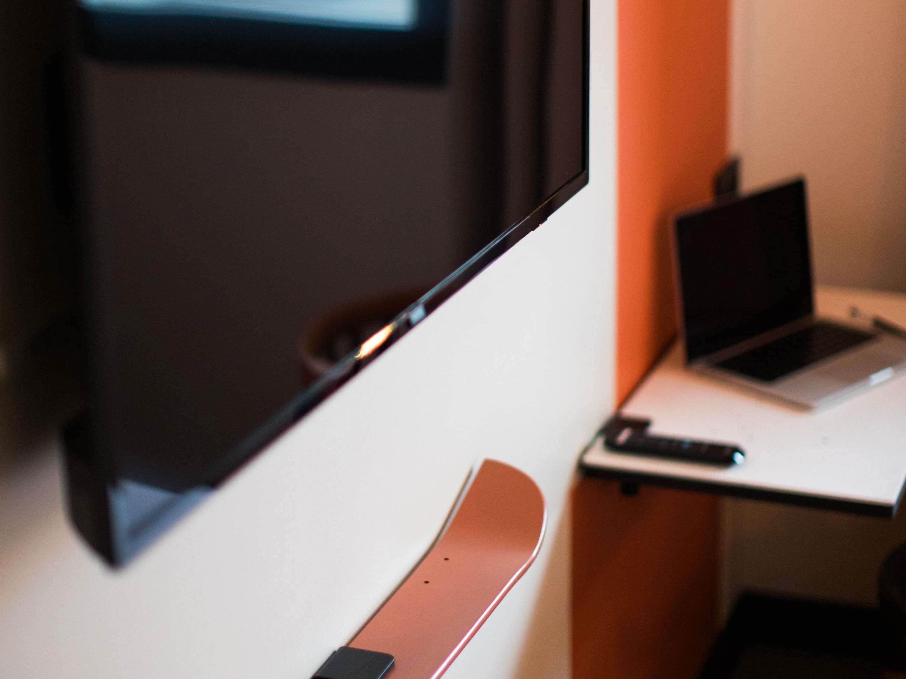 A laptop on a desk with a keyboard and a mouse.