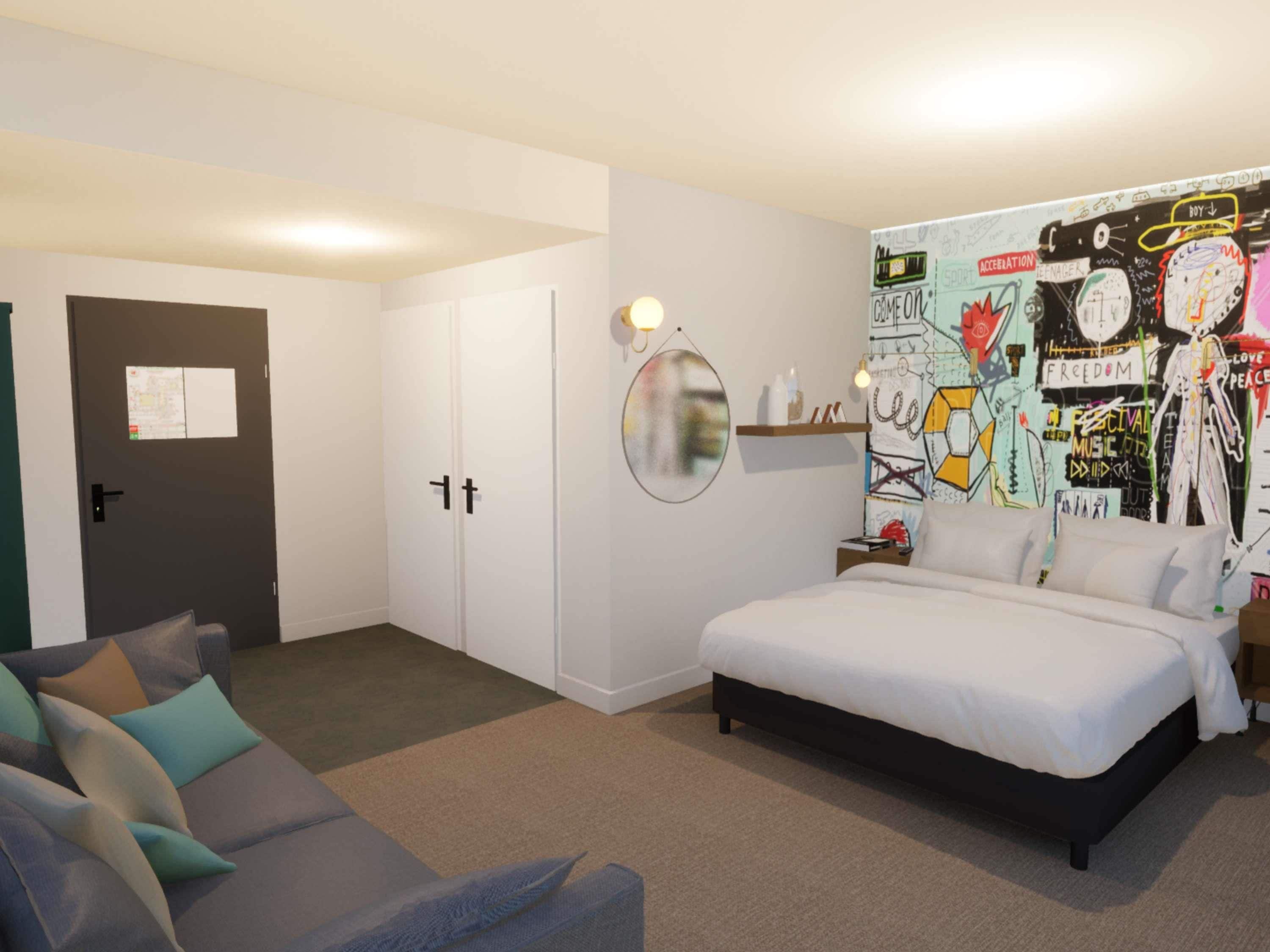 A bedroom with a bed, a couch, a wardrobe, and a wall with graffiti art.