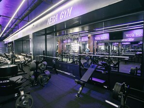 A gym with weightlifting equipment, benches, and mirrors. - ibis Styles Batumi  (Batumi)
