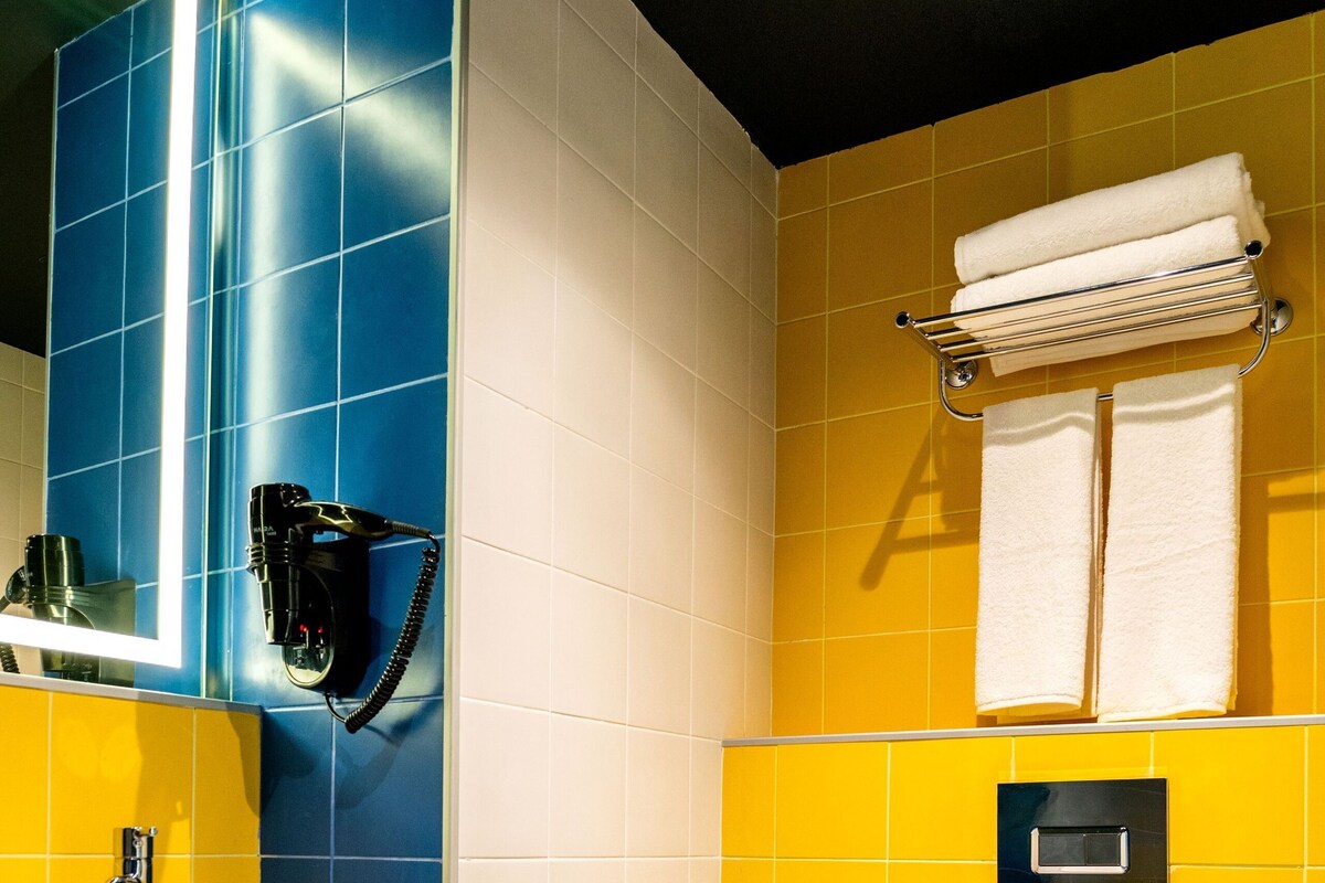 A bathroom with a white sink, a toilet, and a towel rack.