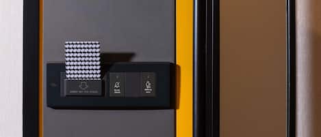 A black and yellow room with a mirror, a black key for power, and a houndstooth-patterned card.