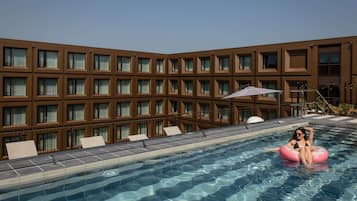 Seasonal outdoor pool, open 11:00 AM to 7:00 PM, pool umbrellas