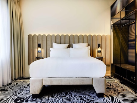 Premium bedding, down comforters, memory foam beds, minibar