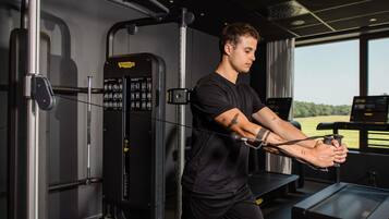 A gym with exercise equipment, a treadmill, and a view of the outdoors.