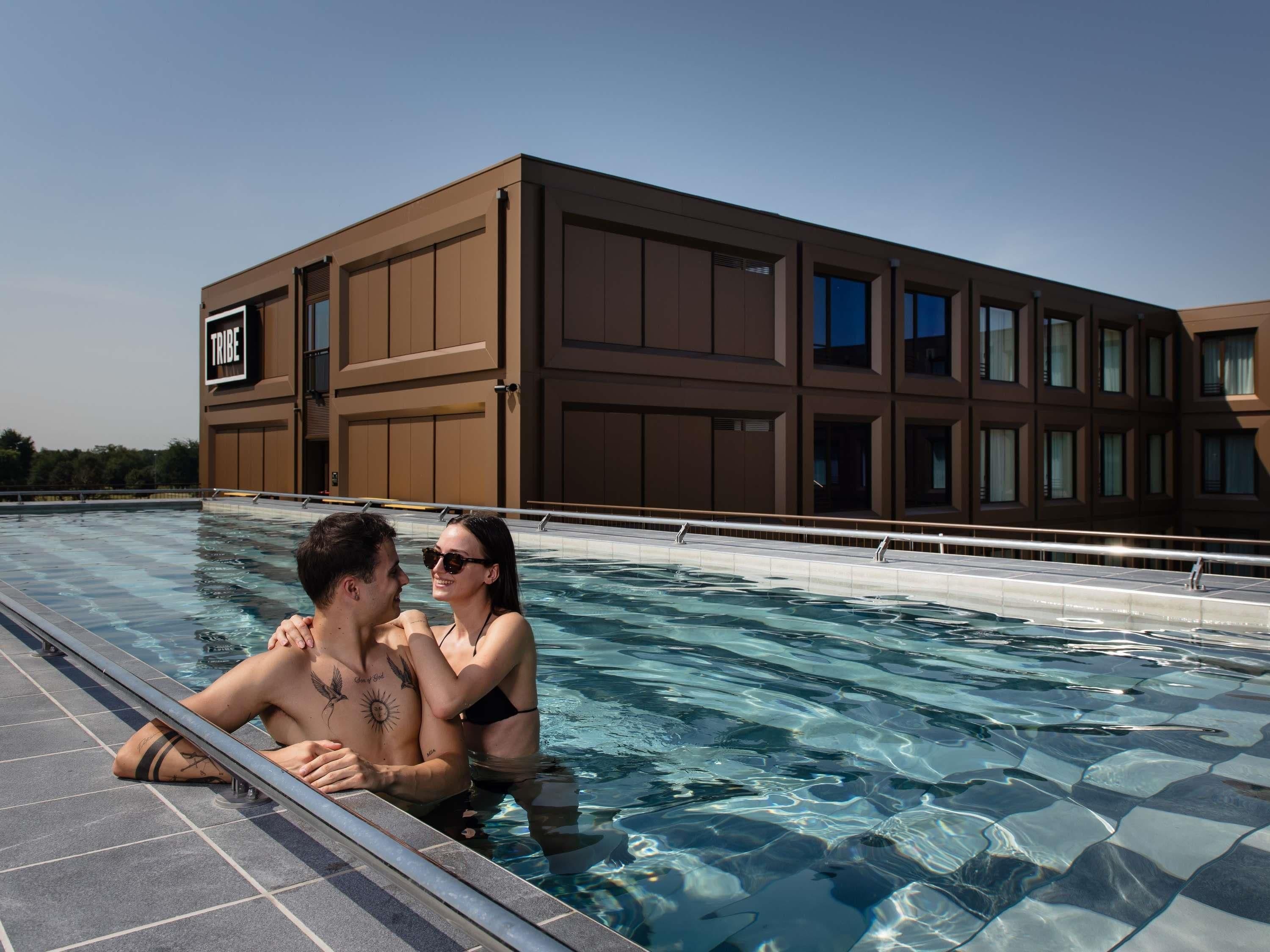 A swimming pool with a modern building in the background.