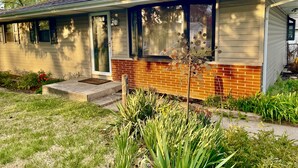 A single-story house with a brick foundation and a sloped roof. - Comfortable 3BR Home-Prime Video, WiFi, Parking (Schererville)
