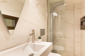 A modern bathroom with a large sink, a mirror, and a shower area. - Antigoni's Seaside Lodge (Rethymno)