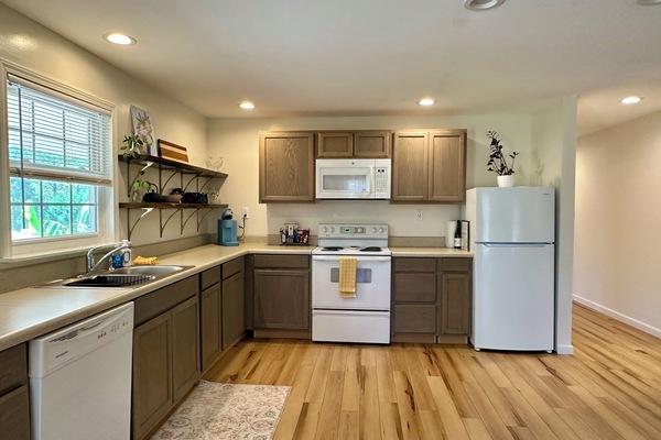 Kitchen with refrigerator, microwave, dishwasher and oven.