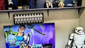 A gaming setup with a TV, gaming consoles, and Star Wars figurines. - The Billiard: super fun home close to downtown with fully-fenced yard (Sanford)