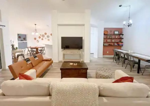 Relax in this stylish living space with a large sofa, coffee table, and flat-screen TV.