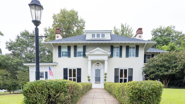 A stately two-story house with a front entrance, a well-maintained lawn, and a street lamp. - Welcome to Summerville! 1.0 miles from the Augusta National (Augusta)
