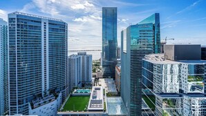 A high-rise urban area with modern skyscrapers, including a prominent building with a reflective glass facade.