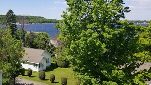 A house with a lawn and a view of a lake.