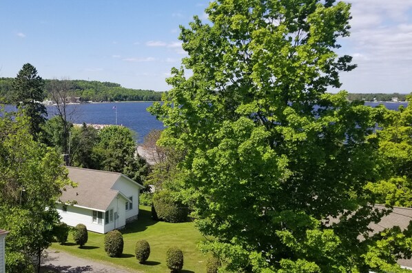 A house with a lawn and a view of a lake.