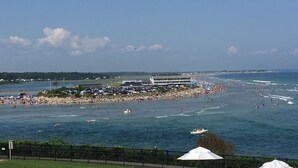 A coastal beach scene with a large building, a fenced area, and a clear sky. - Historical charm | Modern amenities | Unbeatable location (Ogunquit)