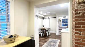 A modern kitchen with a wooden countertop, a dining area with a table and chairs, and a staircase leading to another level. - Historical charm | Modern amenities | Unbeatable location (Ogunquit)