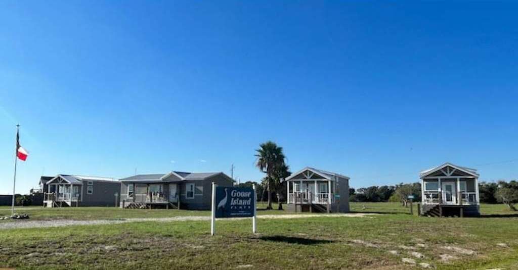 A row of small, single-story houses with a sign indicating 'Goose Island'.