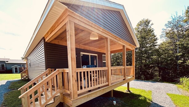 A wooden cabin with a porch, a staircase, and a gravel path. - Cozy Cabin Boarding Winslow Hill Elk Viewing Area! (Benezette)