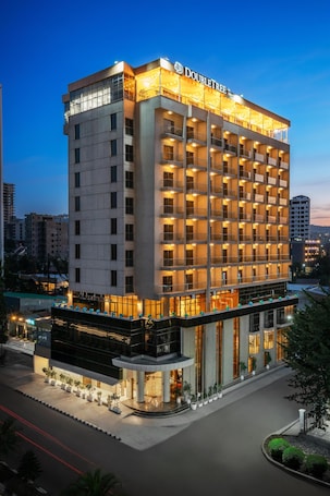 A multi-story hotel with a modern design, featuring a prominent DoubleTree logo.