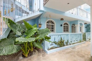 Enjoy the serene atmosphere of this two-story building, featuring a spacious patio area and a charming balcony with arched windows.