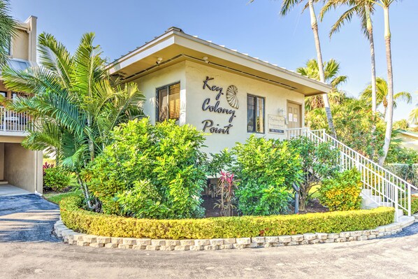 A building with a sign reading "Key Colony Point." - Classic & Comfortable Oceanfront Condo (Key Colony Beach)