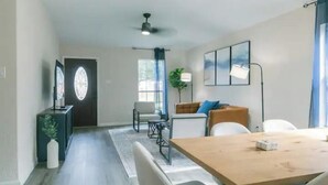 Een moderne woonkamer met een eettafel, banken en een salontafel.