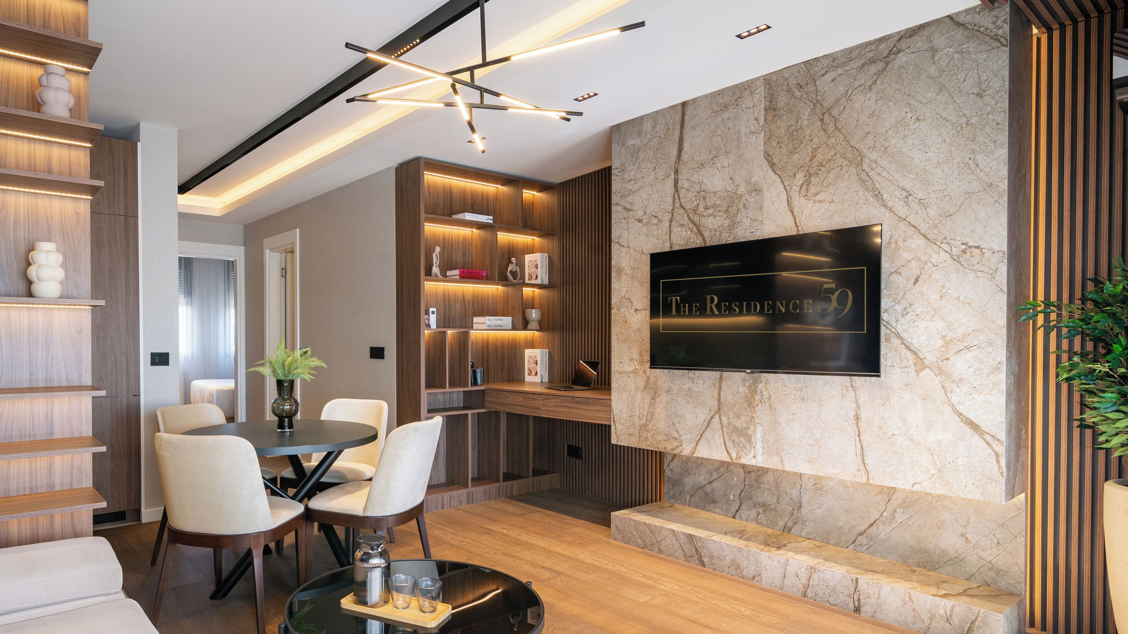A modern living room with a fireplace, wooden shelving, and a dining area.