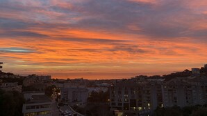 A cityscape at dusk with a sunset sky.