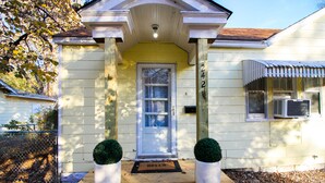 A house with a front door, number 242, and a welcome mat. - Short Drive to Friends Uni - Quaint Cottage W/ W&D (Wichita)