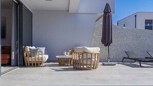 An outdoor pool area with lounge chairs, a table, and an umbrella. - Villa MI by Interhome (Pula)