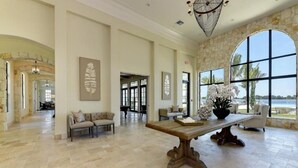 A spacious interior with a large dining table, seating area, and large windows offering a view of the outdoors. - Lake Front View, 6 miles from beaches (Nokomis)