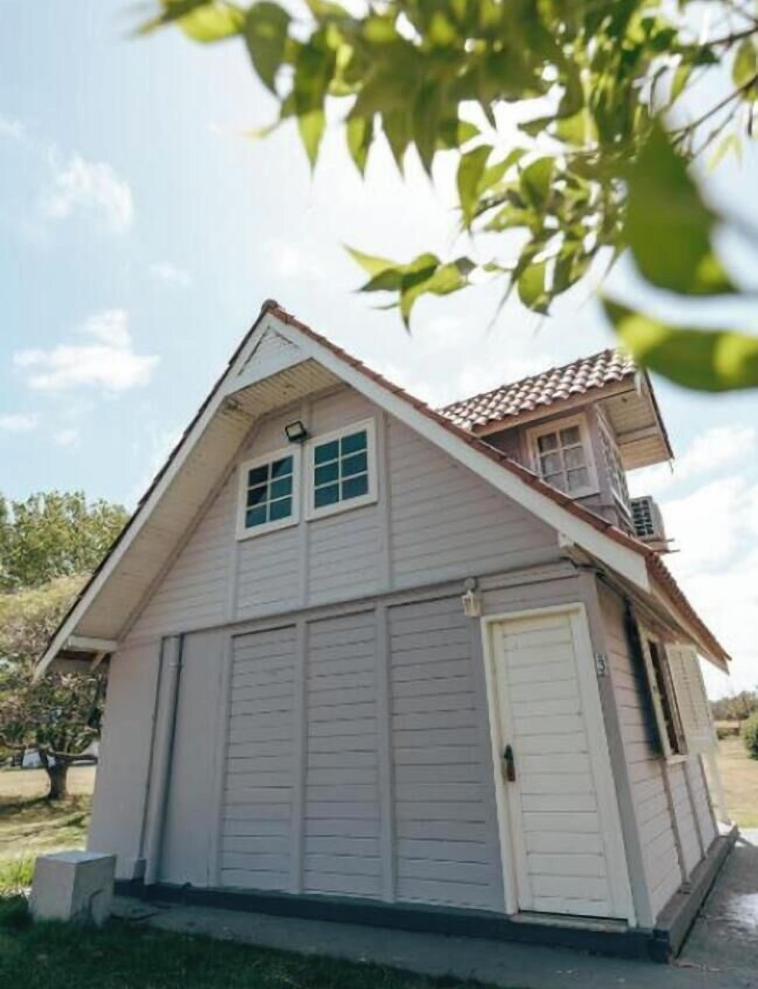 A single-story house with a garage, a small balcony, and a sloped roof.