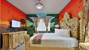 Une chambre à coucher avec un lit, une télévision et une fresque murale.