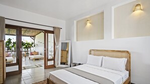 Ein modernes Schlafzimmer mit einem großen Bett, einer Schiebetür zum Balkon und Blick ins Freie.
