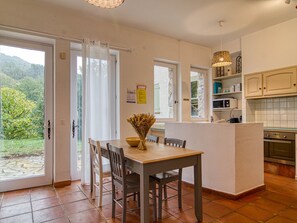 Enjoy meals in the kitchen with an oven and microwave, and dine at the wooden table with two chairs.