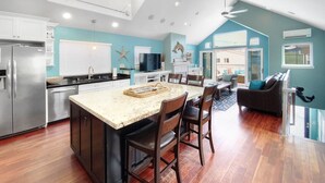 A spacious kitchen with a large island, modern appliances, and a dining area with a view.
