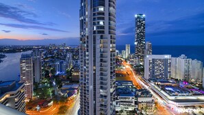 A high-rise hotel with multiple floors, a prominent corner location, and a view of the surrounding cityscape and coastline. - Chevron Renaissance - WOWSTAY (Surfers Paradise)