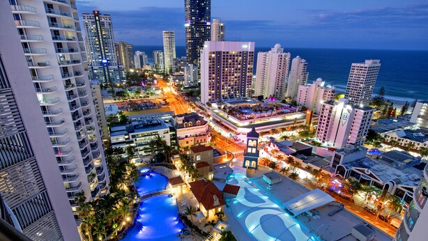 A high-rise hotel with a rooftop pool, multiple balconies, and a view of the city skyline and ocean. - Chevron Renaissance - WOWSTAY (Surfers Paradise)