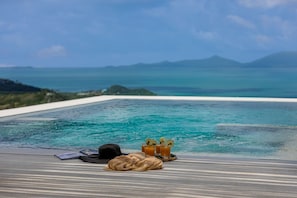 A poolside view with a clear view of the ocean and distant mountains. - Lilly Belle (Koh Samui)