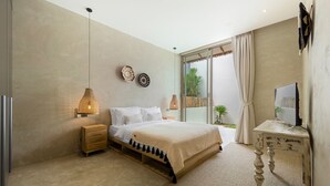 A modern bedroom with a large bed, bedside lamps, a TV on a side table, and a view of the outdoors. - Lilly Belle  (Koh Samui)