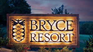 A wooden sign with the text "Bryce Resort" and a pineapple graphic. - Holocene Chalet - treetop mountain views! (Basye)