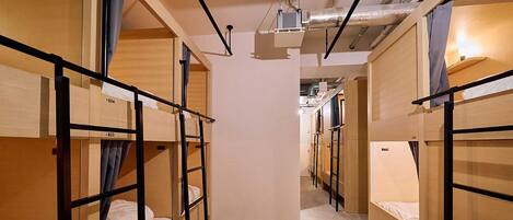 A corridor with bunk beds, each marked with a number.