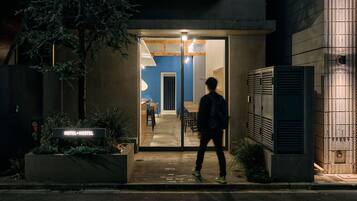 A hotel entrance at night with a person walking in.