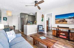 A modern living room with a sofa, coffee table, and a TV stand. - 2/2 Oceanview Modern Resort Vistas (Kihei)